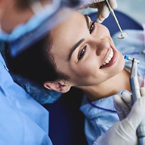 Woman in dentists chair smiling