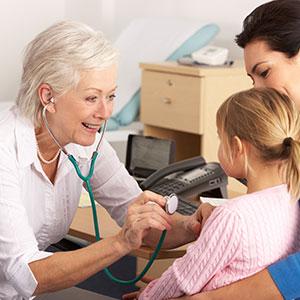 Female GP checking child with a stethoscope
