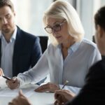 Group of directors sat at board table