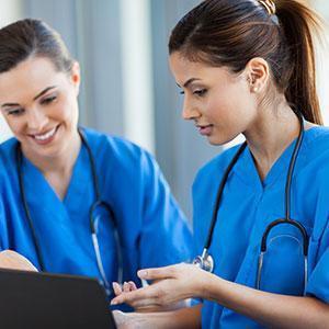 Two female nurses talking