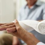 Man having hand bandaged