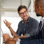 Man in glass explaining in business meeting