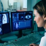 Female radiographer looking at monitors