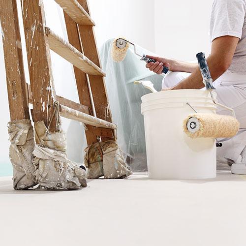 Close up of man painting a wall
