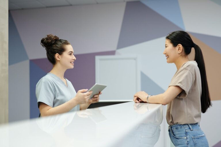 a woman talking to a receptionist